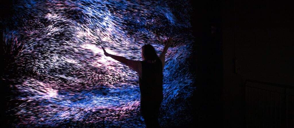 WNDRWall is an LED screen with waves of blue, pink, and white lights rippling across the screen.